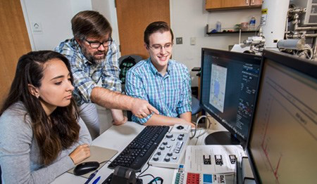 Dr Nate Magee (center) with students Katie Boaggio and Lucas Bancroft work with their Hitachi-Quorum cryo-SEM at TCNJ.